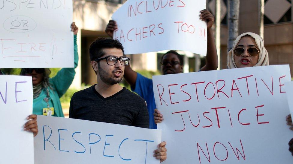 Muhammad Nasim Ul Ghani (L) and Nadine Aly join with other protesters in front of the Broward County School Administrative building demanding action concerning a teacher accused of using an ethnic slur against a Muslim student on March 11, 2015 in Fort Lauderdale, Florida.