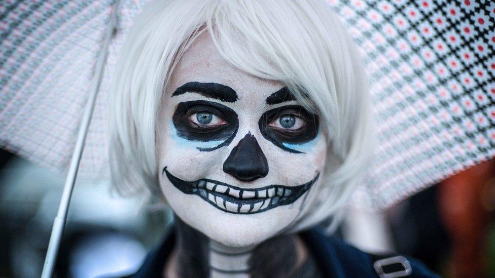 A woman with skeleton face paint