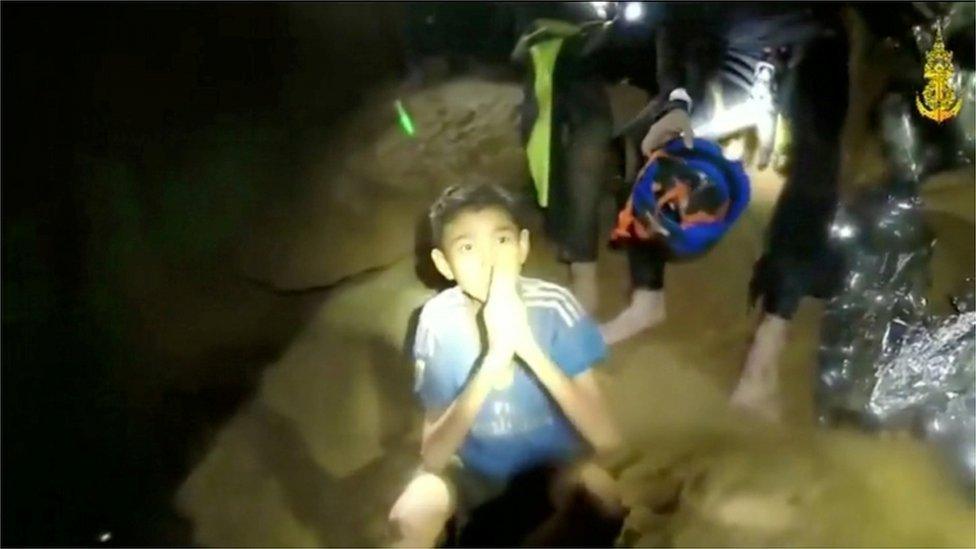 One of the boys trapped in a cave in Thailand greets rescuers