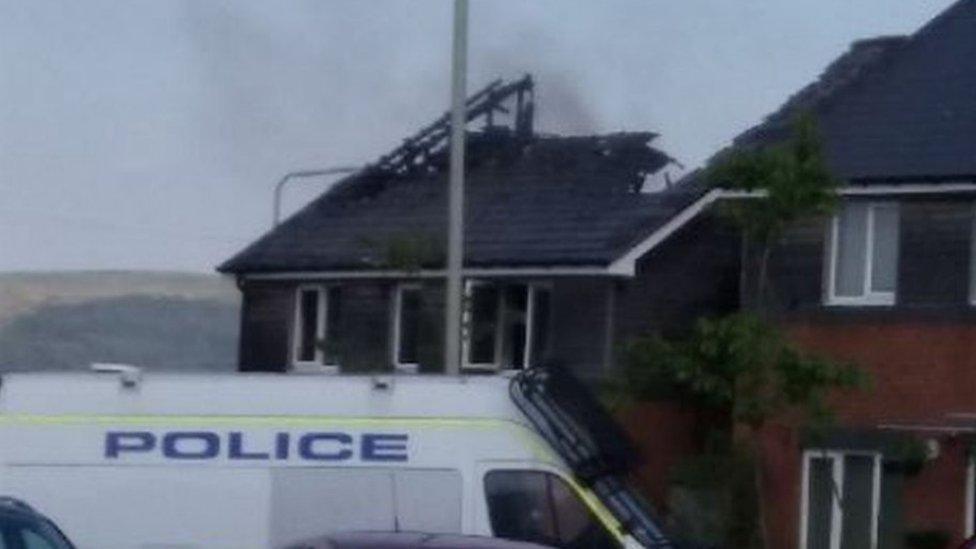 The badly damaged roof of the house folloiwng the fire