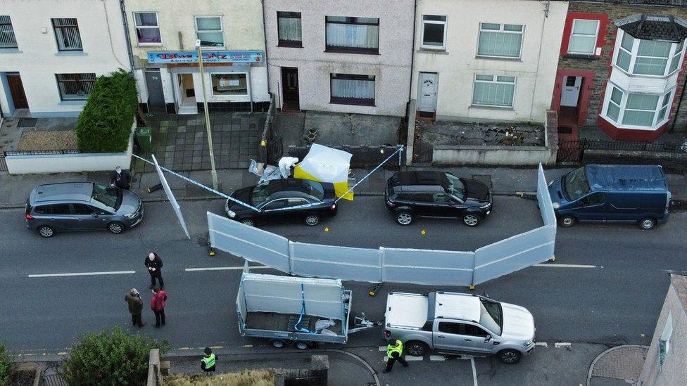 A white fence surrounds the scene in Treorchy