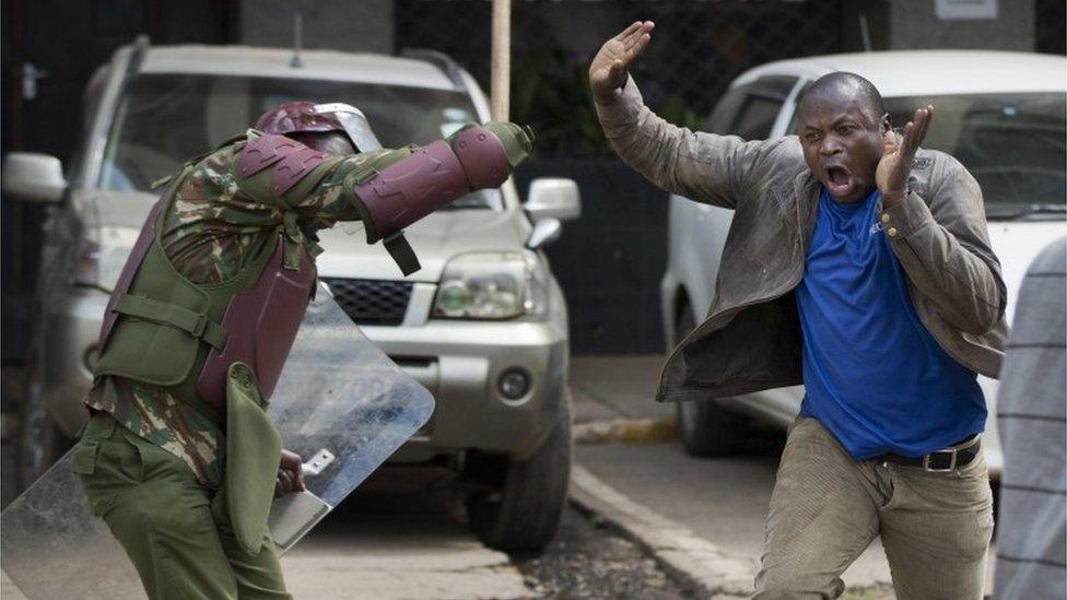 An opposition supporter yells out as he is beaten with a wooden club by riot police while trying to flee, during a protest in downtown Nairobi, Kenya Monday, May 16, 2016.