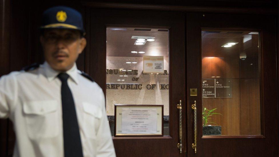 A security guard stands next to an entrance to South Korea"s Consulate (Consulate General of the Republic of Korea) in the Far East Finance Centre in Admiralty, Hong Kong, China, 28 July 2016.