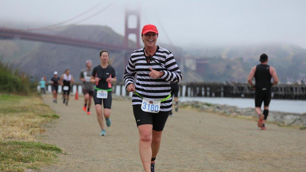 Sally Orange running with Golden Gate Bridge in background