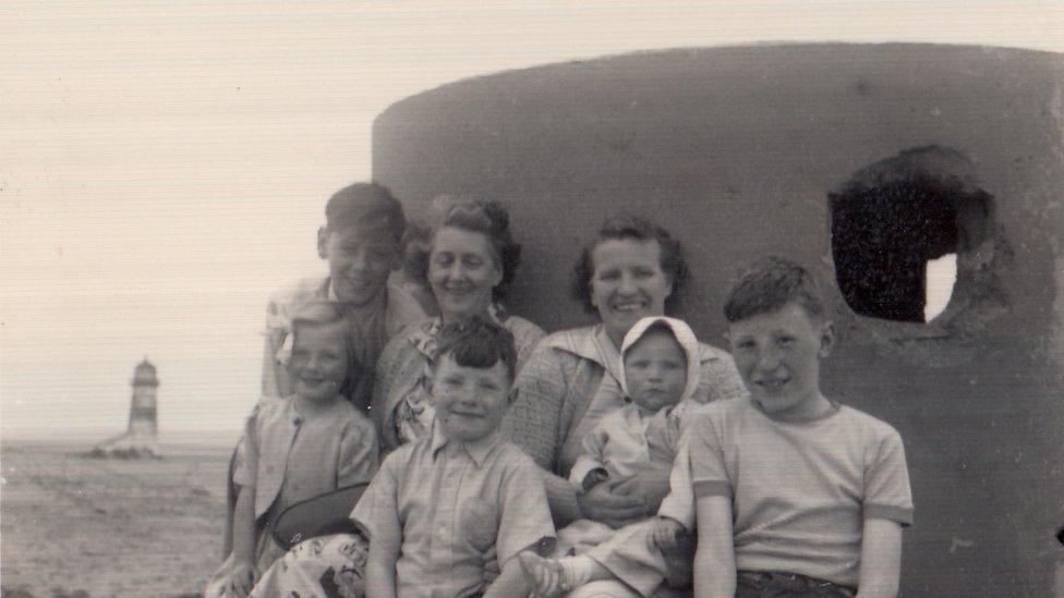 Family posing at pill box on Talacre beach