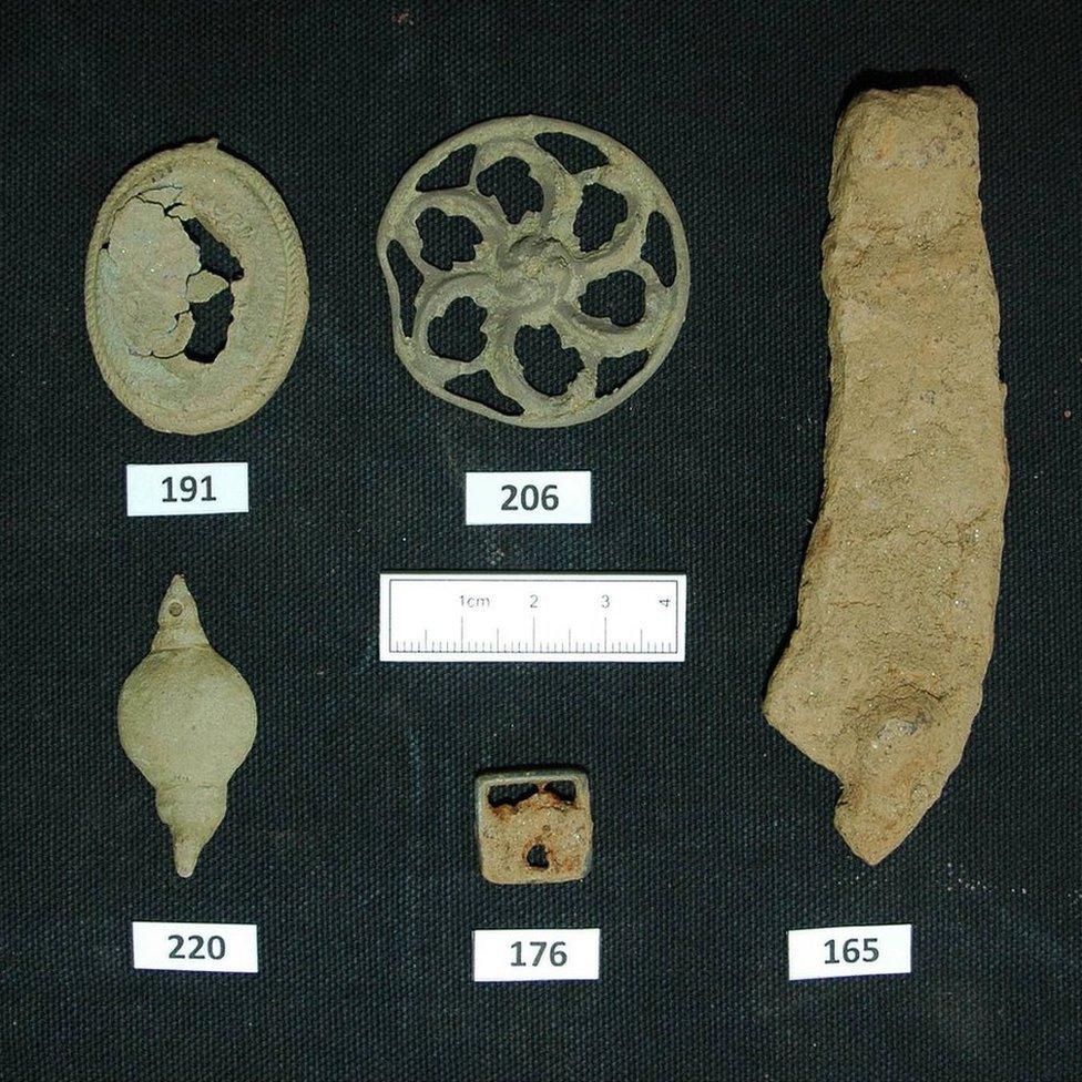 Horseshoe fragment (165), harness boss (206), pendant (191), sword belt fitting (220), and shoe buckle (176)