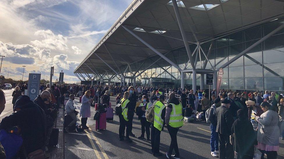 People outside Stansted Airport while the evacuation takes place