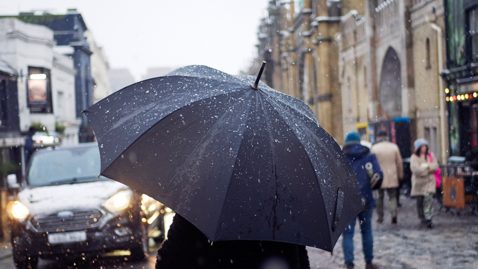 Person with an umbrella in the centre of Brighton