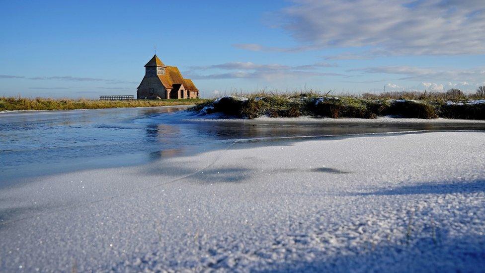 Frozen dykes surround the St Thomas Becket church on Romney Marsh in Kent