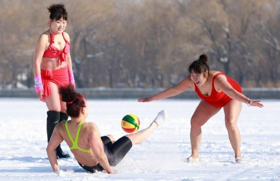 Women play ball games on a snow-covered field in Shenyang, China