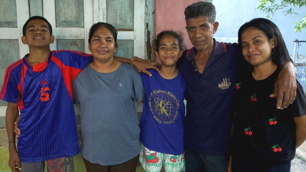 Meriance with her husband and three children