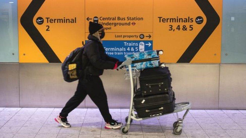 Passenger wears face mask at Heathrow Airport