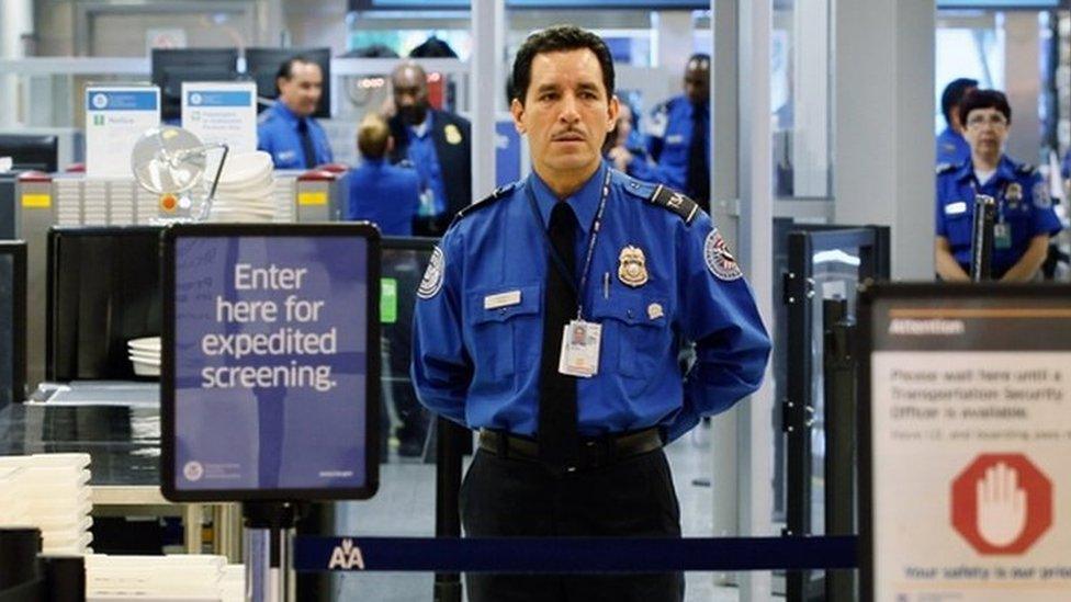 TSA security officer stands at a checkpoint