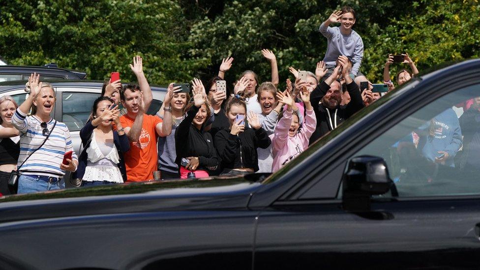 Crowds cheering the couple