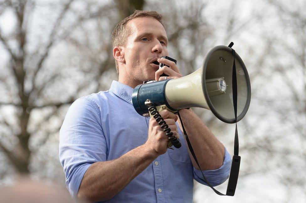 the governor speaks with a bullhorn