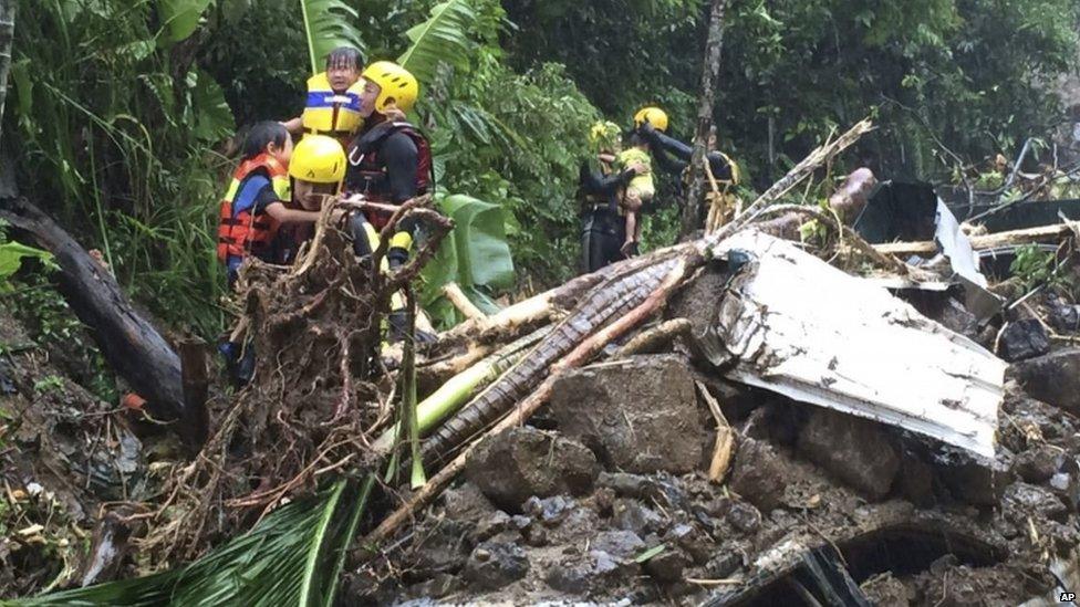 Rescuers carry children after mudslide in Xindian, northern Taiwan - 8 August