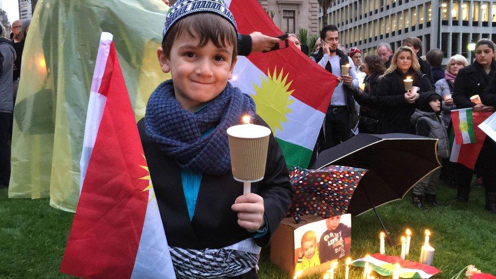 Karez Najifar, 5, dressed in traditional Kurdish dress during a refugee vigil at Melbourne's Treasury Gardens