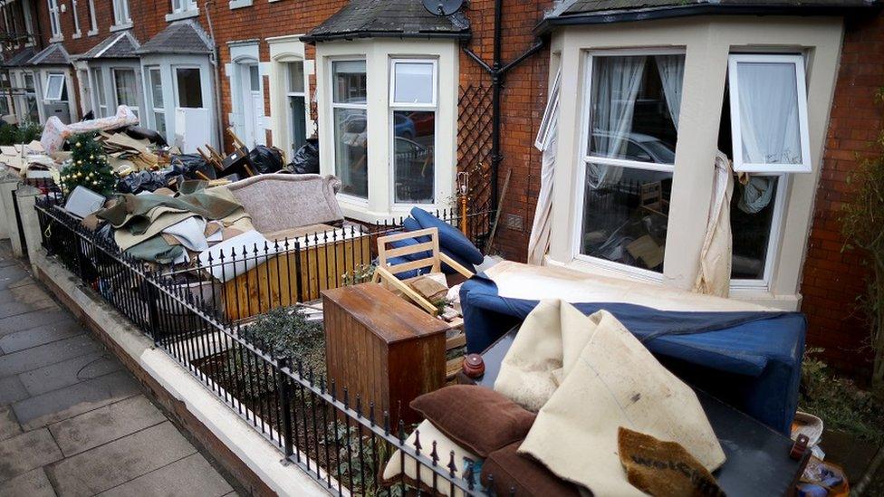 Water-damaged possessions sit outside a flooded home in Carlisle after flooding created by Storm Desmond