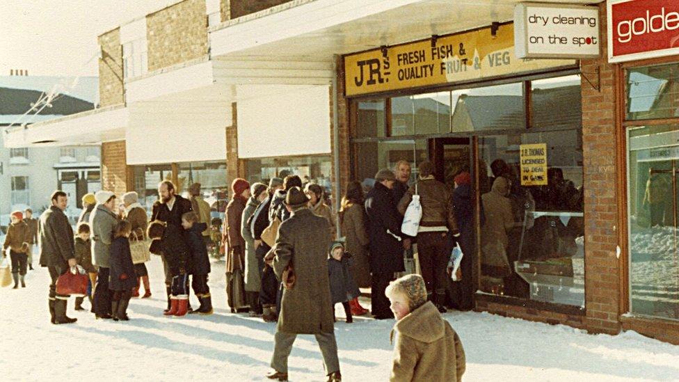 People queue outside a greengrocers in the snow - Swansea 1981