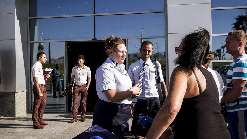 Travel representatives help tourists outside Harmel-Sheikh airport