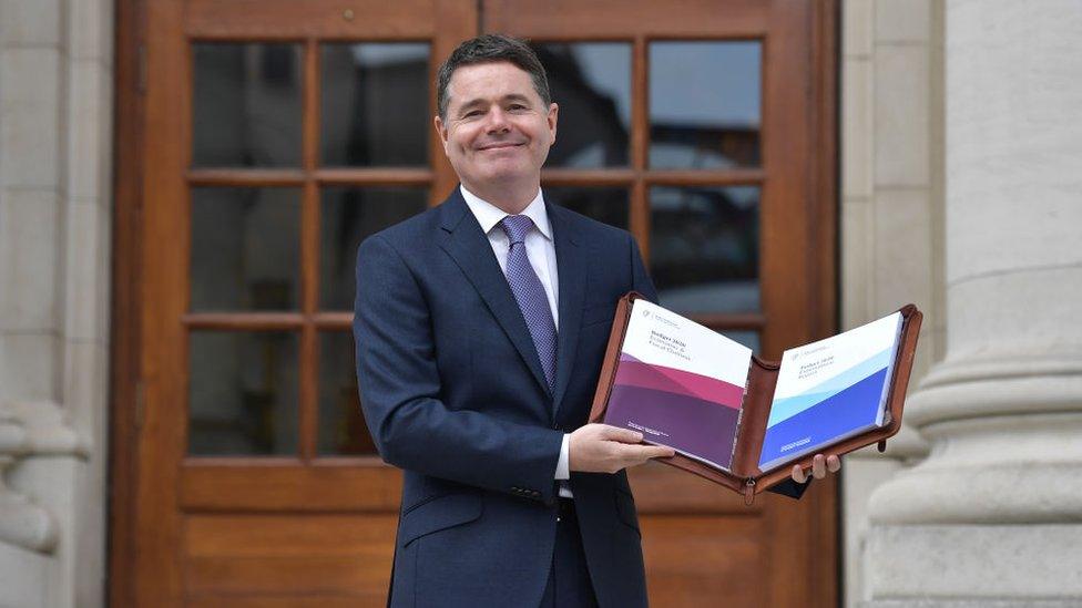 Paschal Donohoe holds a folder containing his Irish budget document