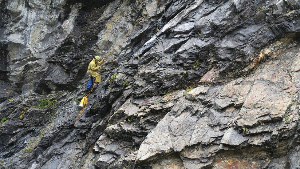 Cave specialist Lee Hollis on the cave wall