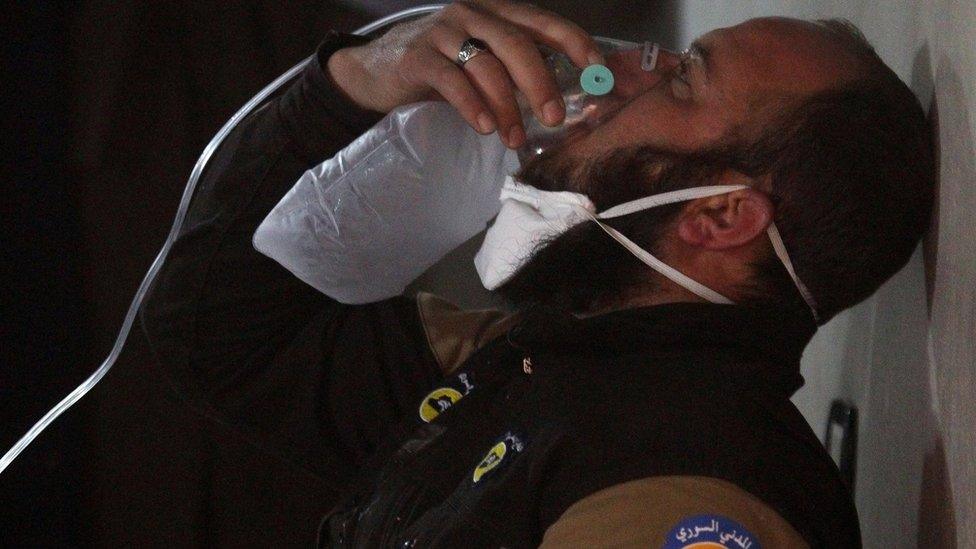 A civil defence worker breathes through an oxygen mask, after a suspected gas attack in the town of Khan Sheikhoun in rebel-held Idlib, Syria, April 4, 2017