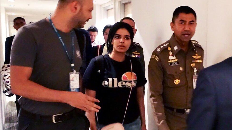 Saudi woman Rahaf Mohammed al-Qunun is escorted by Thai immigration and UN officials at Bangkok's Suvarnabhumi international airport in Bangkok