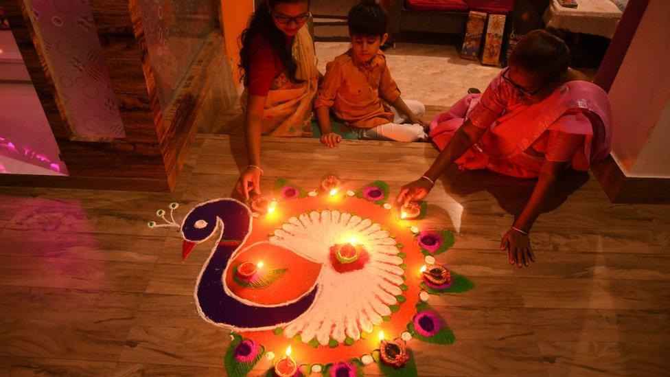 Women light earthen lamps on the occasion of Diwali festival in Nagaon District of Assam ,India on Oct 24,2022. (Photo by Anuwar Hazarika/NurPhoto via Getty Images)