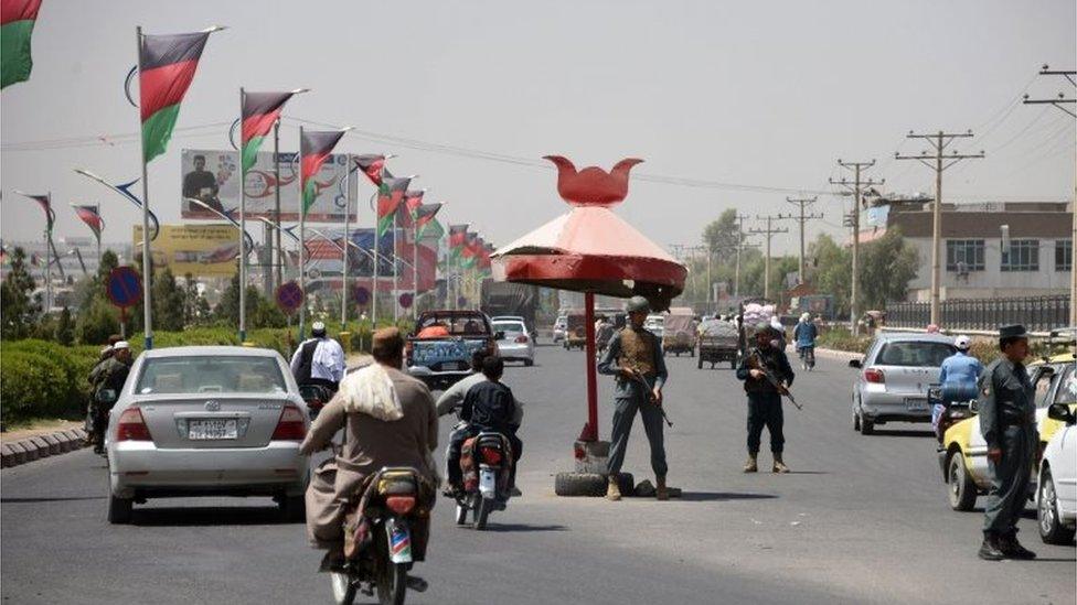 Afghan policemen stand guard at a checkpoint ahead of parliamentary election in Kandahar on October 18, 2018.