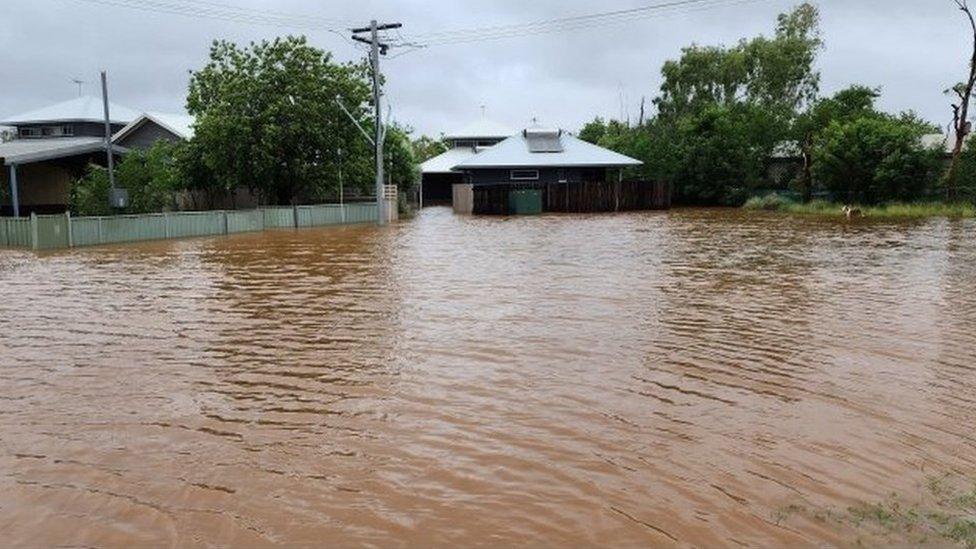 Flooded road and house in western Australia