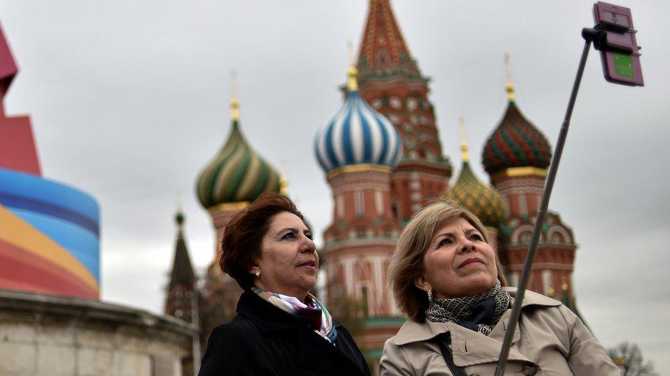 Tourists using a selfie stick in Moscow