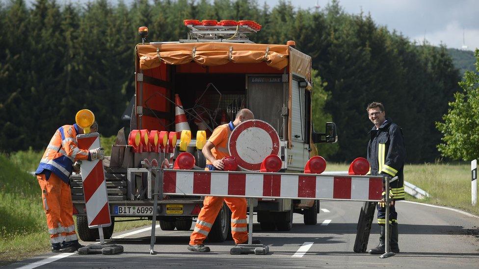 Firemen block a street in Lünebach on June 1, 2018