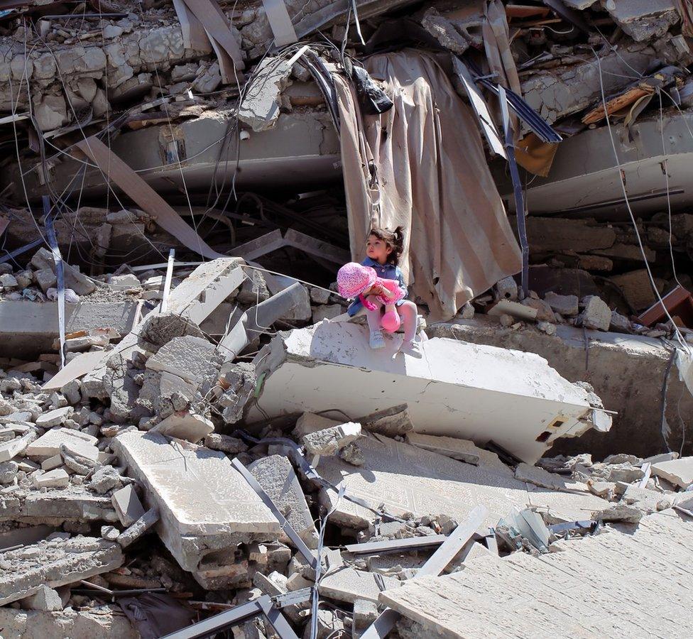 Celine by Shaban El Sousi - a photo showing a two-year-old Palestinian girl sitting on the ruins of a tower block in Gaza in May 2021