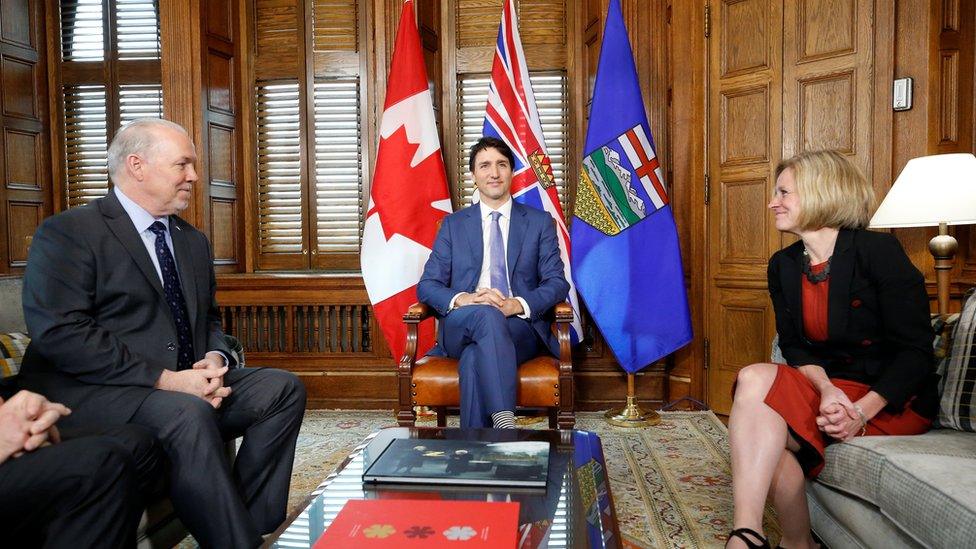 Canadian PM Justin Trudeau held an emergency meeting with the premiers of BC (L) and Alberta (R) on Sunday