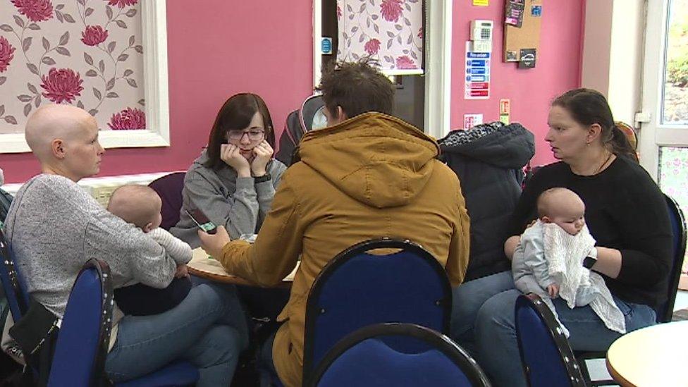 People sitting around a table in a cafe