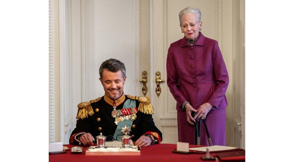 Queen margarether watches her son sign a document