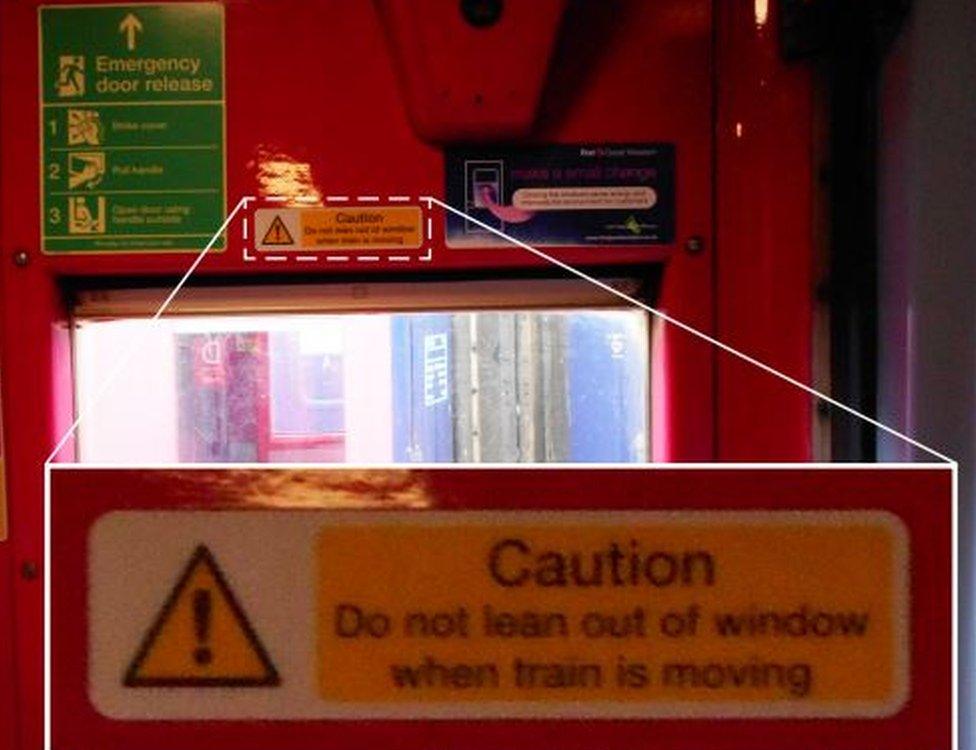 Warning sign by train window