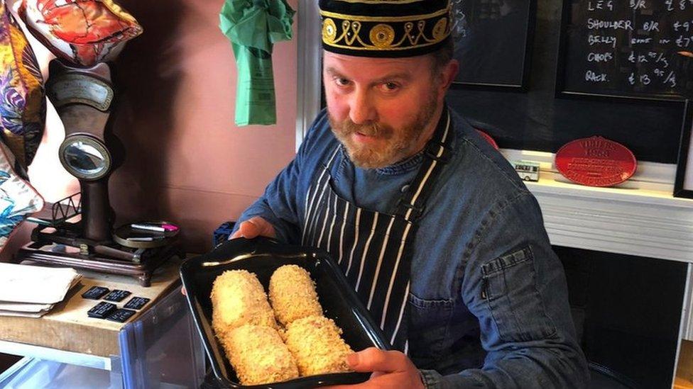 Andrew Moore holding Chicken kievs in a pan