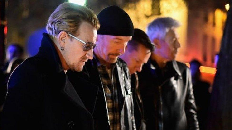 U2 paid their respects near the Bataclan concert hall in Paris on Saturday