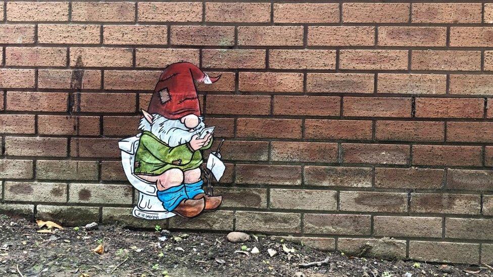 Image of gnome on toilet artwork