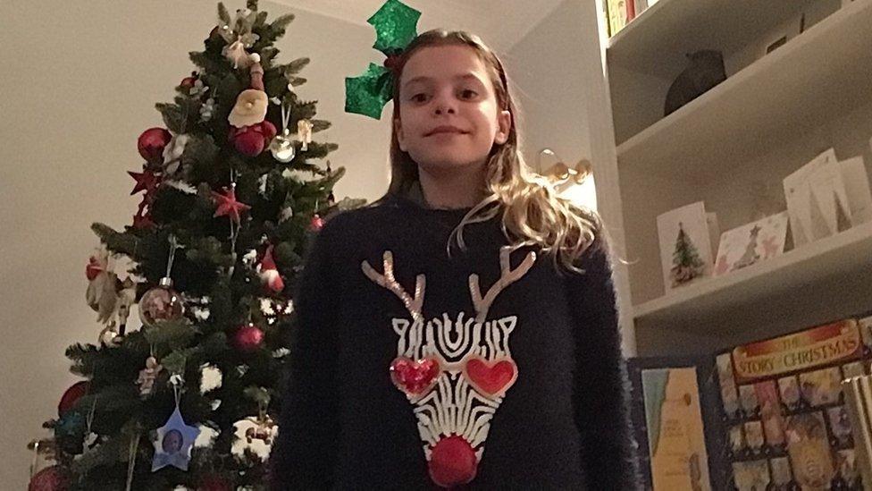 Girl in Christmas jumper.