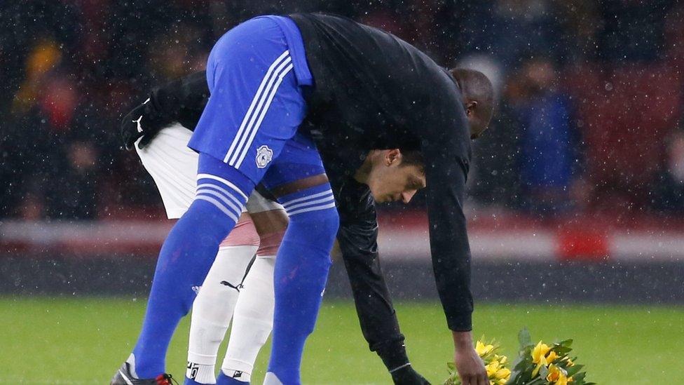 Captains Mesut Ozil (left) of Arsenal and and Cardiff City's Sol Bamba (right) laid bunches of daffodils before the game kicked off