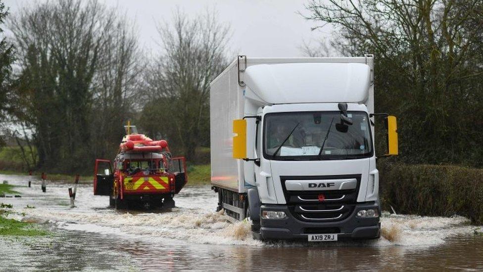 Hereford Fire and Rescue test the depth of flood water in the village of Hampton Bishop in Herefordshire, western England