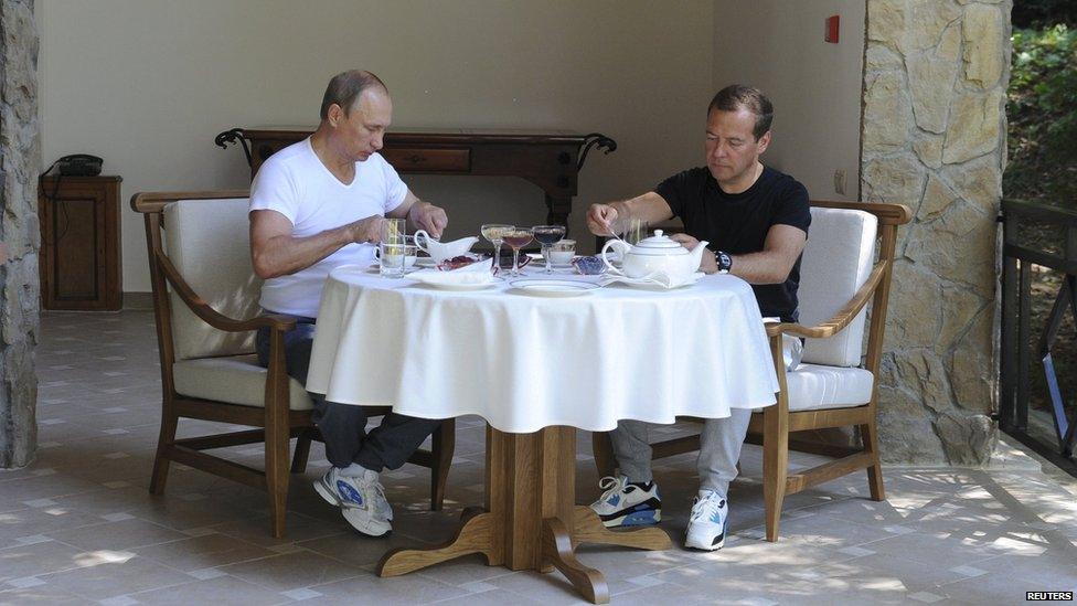 Russian President Vladimir Putin (L) has breakfast with Prime Minister Dmitry Medvedev at the Bocharov Ruchei state residence in Sochi, Russia, August 30, 2015.