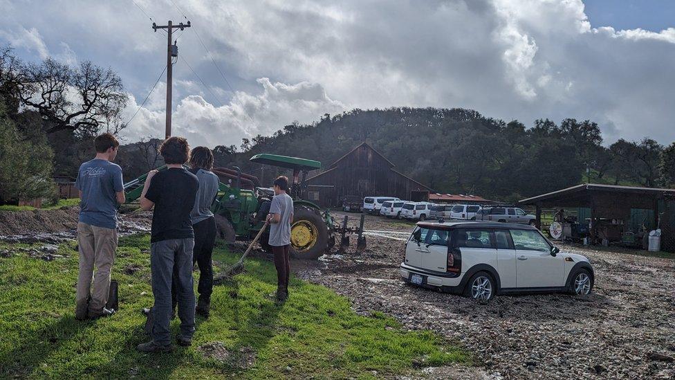 High school students volunteered between classes to clean up muddy flood debris