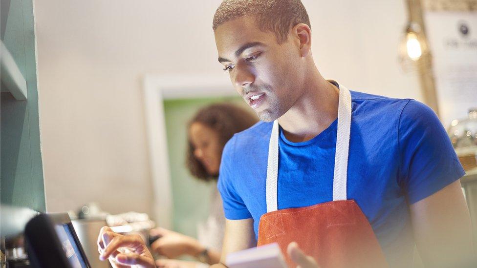 Barista using till