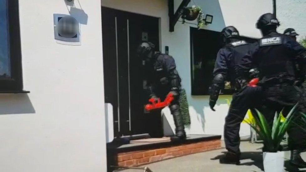 Officers conducting a raid on a property in Brighton Road, Purley, where a 40-year-old man was arrested as part of a NCA operation aimed at dismantling an organised crime group involved in transporting hundreds of Albanian migrants to the UK illegally