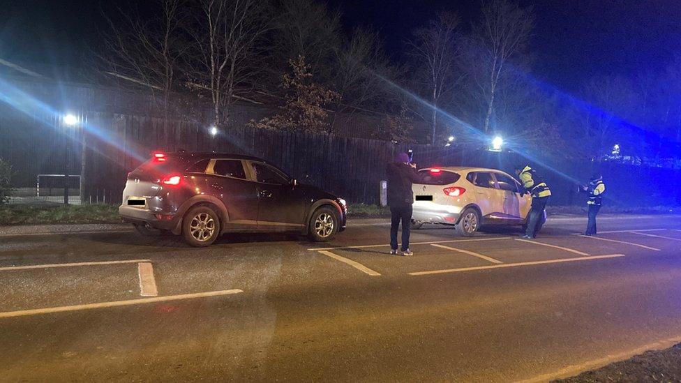 Police stopping cars near the car park where Det Ch Insp John Caldwell was shot