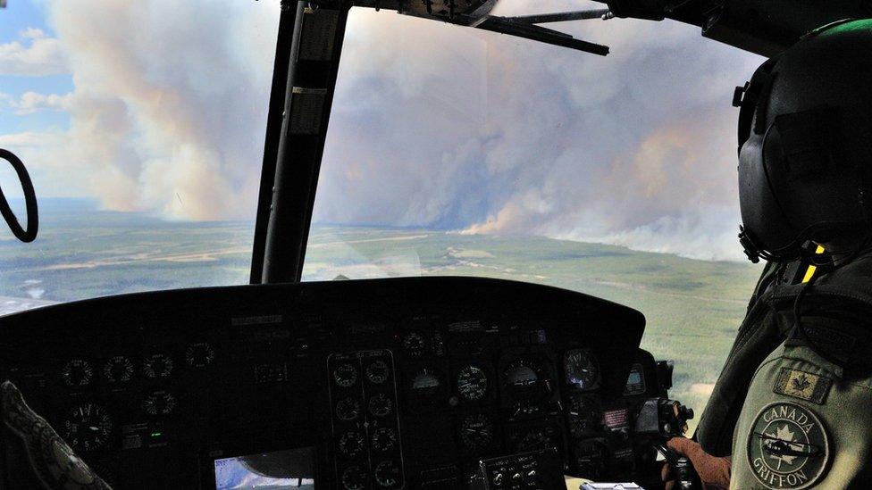 Members of the 408 Tactical Helicopter Squadron, Edmonton fly a CH-146 Griffon to view the damage created by wild fires in the Fort McMurray (07 May 2016)